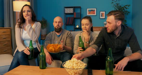 A Group of Good Friends From College are Relaxing on the Couch in the Evening