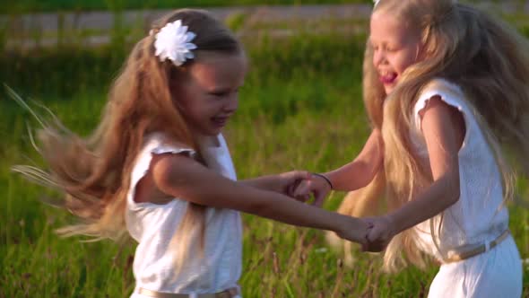 Children Play and Laugh Running Around the Field in Summer