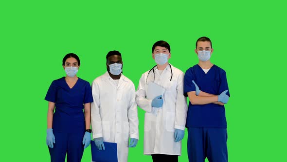 Multiracial Group of Young Doctors Stand Straight in Front of Camera on a Green Screen Chroma Key