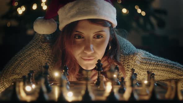 Girl plays chess at Christmas