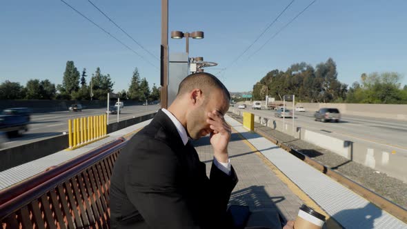 Businessman in a suit waits for a train