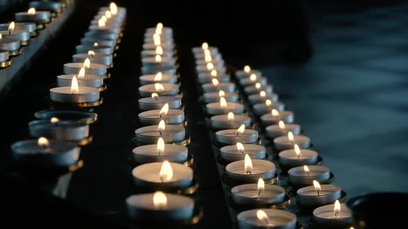 Rows of Burning Lit Candles in Catholic Cathedral