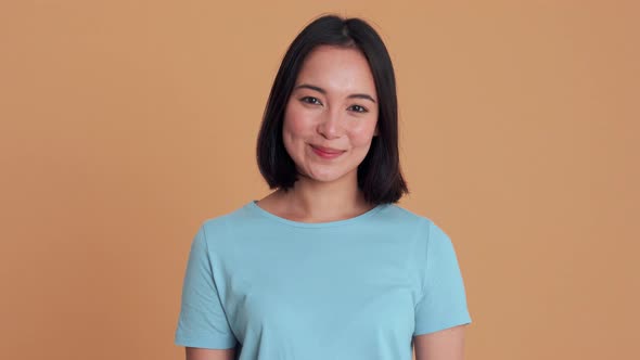 Smiling woman in blue t-shirt looking at the camera