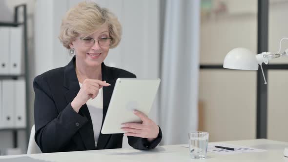 Old Businesswoman Talking on Video Chat on Tablet