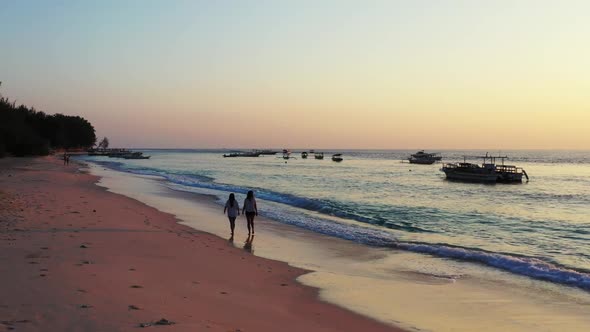 Beautiful ladies enjoying life on idyllic coastline beach time by clear ocean and white sand backgro