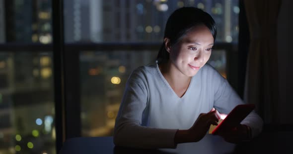 Woman use mobile phone online at home