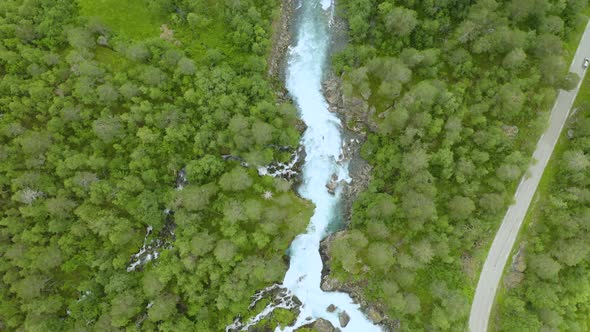 Lush Green Forest And Beautiful Narrow Stream In Gudbrandsjuvet, Norway - aerial shot