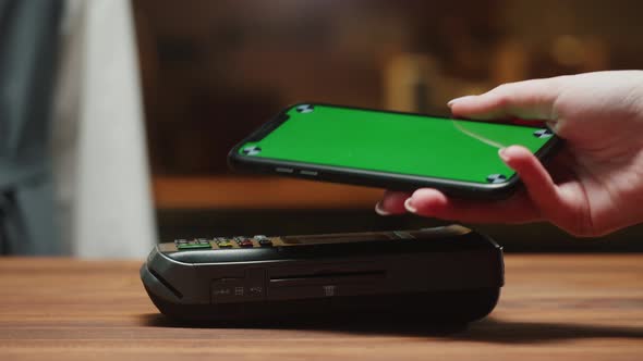 Paying By Smartphone with Chroma Green Screen Closeup