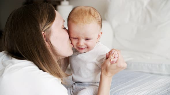 Joyful Mom Communicating with Adorable Baby Daughter