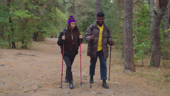 Joyful Multiracial Couple on Trek in Autumn Forest