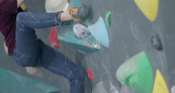 Climber Training on a Climbing Wall Female Practicing Rockclimbing Mountaineer Training Moving Up