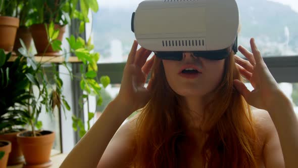 Woman using virtual reality headset in living room 4k