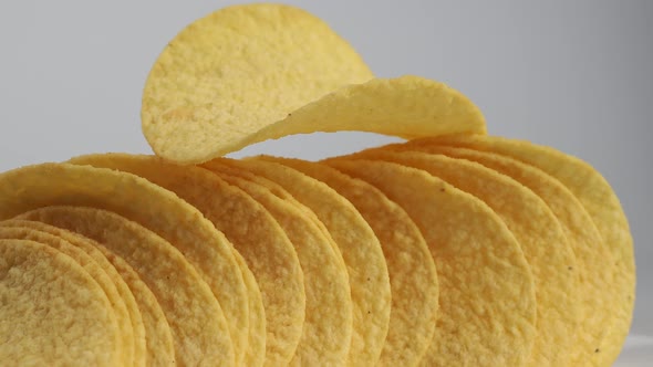 Fried potato chips rotating on a white background. Crispy chips.