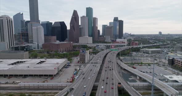 Aerial view of traffic on freeway near downtown Houston on a cloudy day during sunset. This video wa