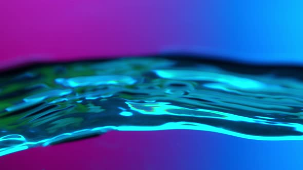 Super Slow Motion Abstract Shot of Swirling Neon Water at 1000Fps