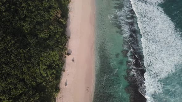 Aerial View of Tropical Beach with Azure Blue Water and Foaming Ocean Waves