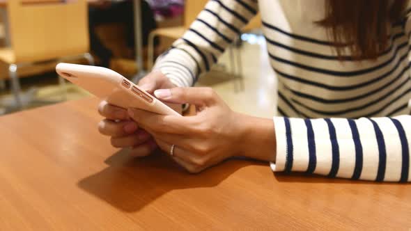 Woman use of mobile phone in restaurant