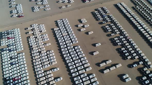 Faraway aerial view of group of cars at parking space on a desert landscape.