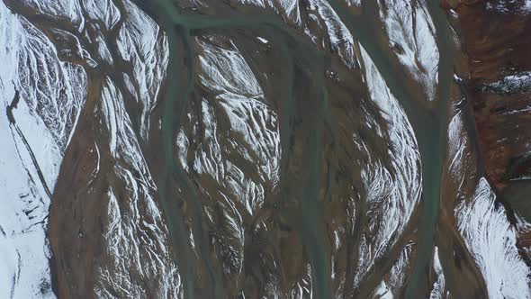 Drone Flight Over Landscape With Snow On Braided River