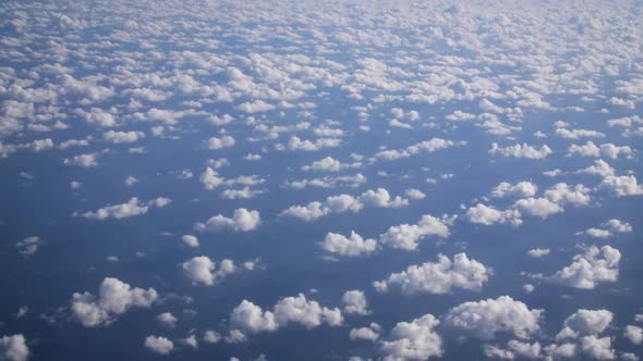 Airplane View. Nice small cirrocumulus clouds pattern from above and immense blue Atlantic ocean und