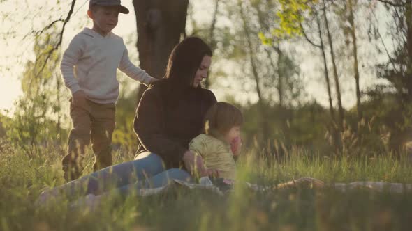 Family at Sunset in the Park Spending Time Together