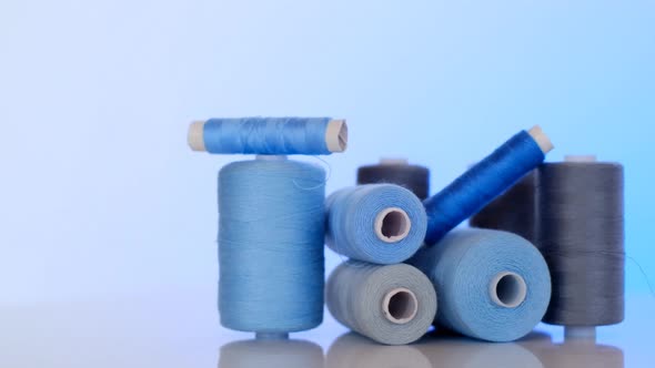 Needlework and sewing. Sewing threads set.Blue and gray thread spools