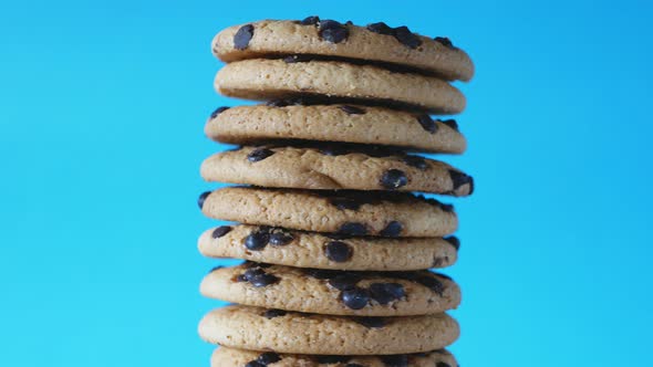 A Stack Chocolate Chip Cookies Rotate on a Blue Background