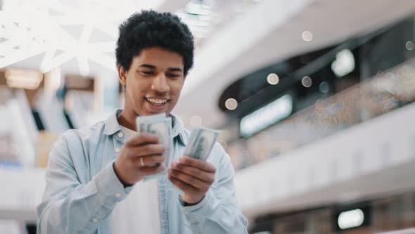 Happy Excited African Man Counting Money Currency Dollars Banknotes Cash Indoors Enjoying Success