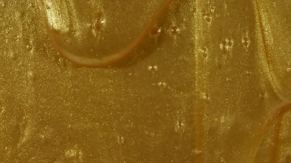 Gold Gel Fluid with Flowing Down on Surface