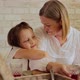 Smiling Daughter Embracing Mother While Having Food at Dining Table - VideoHive Item for Sale
