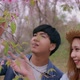 Slow motion romantic moment of young Asian couple dating while pink Sakura tree. - VideoHive Item for Sale