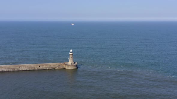 A Lighthouse and Breakwater at the Mouth of a Harbour in the UK