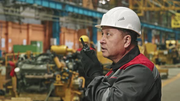 Portrait Of Plant Supervisor Talking On Walkie-Talkie