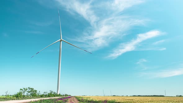 Wind Driven Generator with Rotating Blades Stands in Field