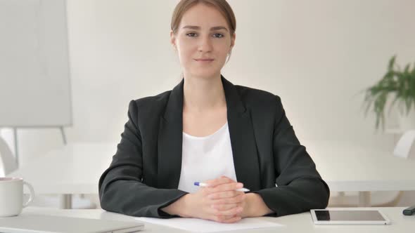 Serious Young Businesswoman in Office