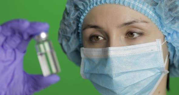Female Scientist Holding Ampoule in Hand, New Medication Developing, Vaccination