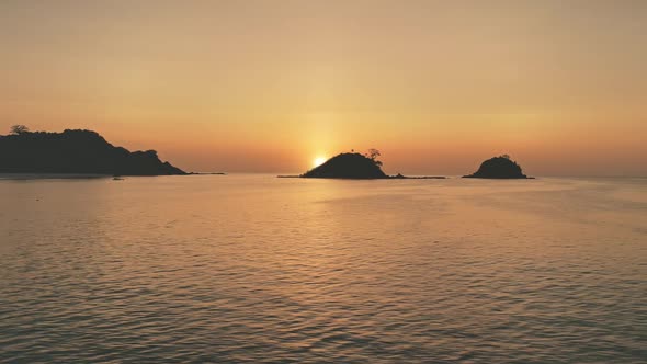 Timelapse of Sunset Seascape at Mountain Island Silhouette Aerial