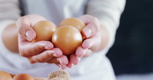 Woman holding brown eggs 4k