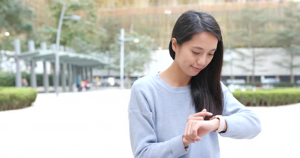 Woman use of smart watch in the city