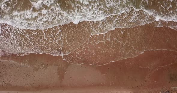 Top Down View of Waves Breaking in the Sand, Flying Over Tropical Sandy Beach and Waves