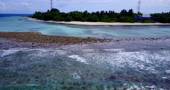 Daytime above island view of a white sandy paradise beach and turquoise sea background in best quali