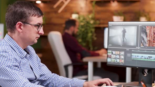 Video Editor in the Office Taking a Sip of Coffee