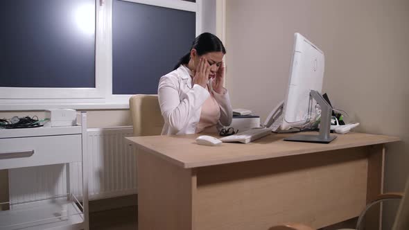 Overworked Doctor Taking Break During Work on Pc