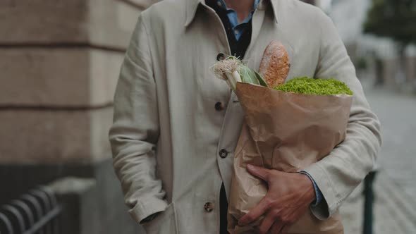 Close Up of Man Carrying Shopping Bag with Fresh Food