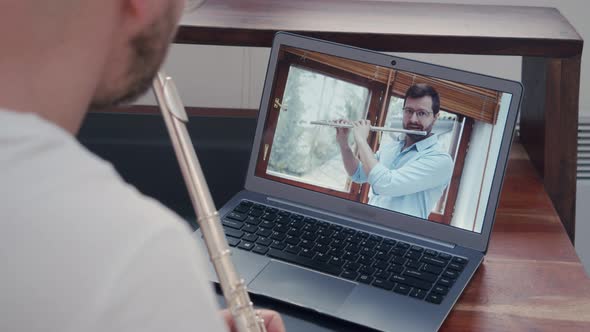 Music Teacher Train Online Lessons on Playing a Wind Instrument on a Flute