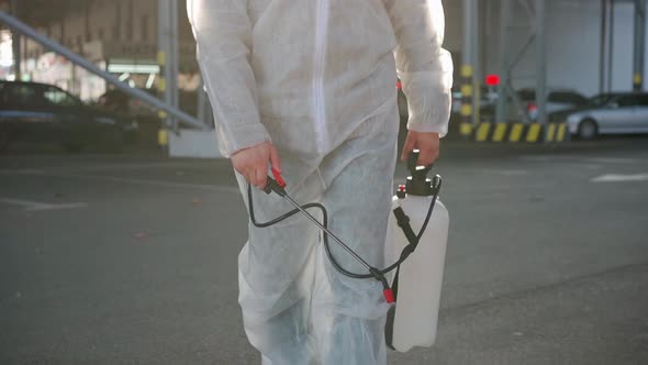 Man Dressed White Protective Overalls Spraying Surface Antibacterial Sanitizer Sprayer During