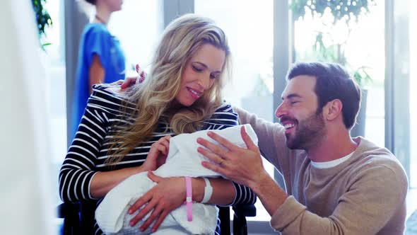 Couple looking at their newborn baby