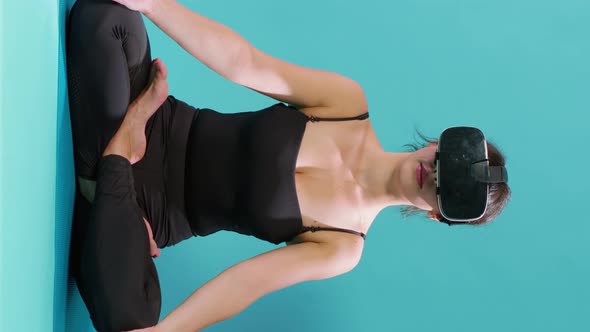 Vertical Video Woman Sitting in Lotus Position with Vr Glasses on Yoga Mat