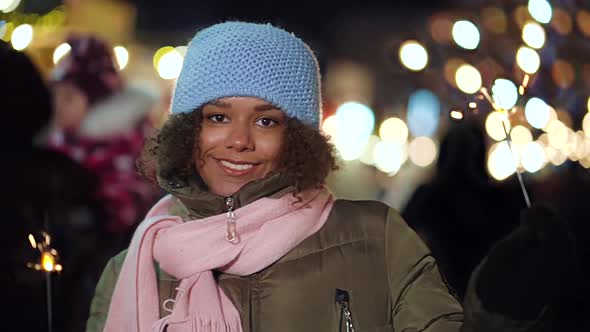Black Girl Playing with Sparklers on Christmas Market