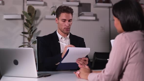 Man Talking to Woman Job Seeker During Business Meeting at Table in Modern Office Spbi